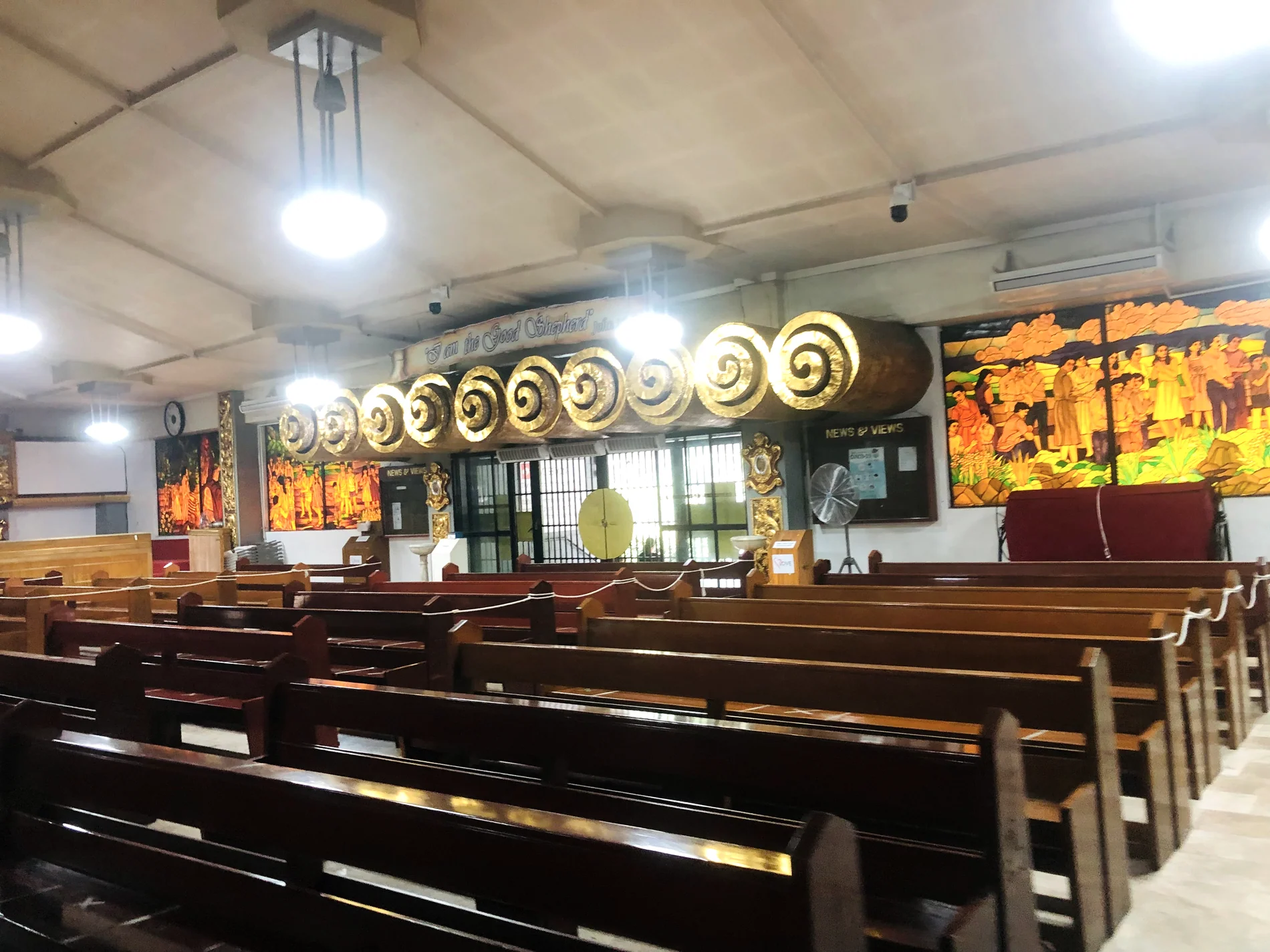 Church pews and side mosaic glass inside Good Shepherd