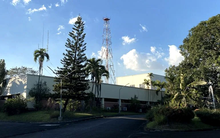 Radio Veritas Asia grounds with the tower and garden under a blue sky